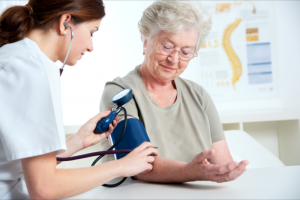 caregiver checking patient's blood pressure